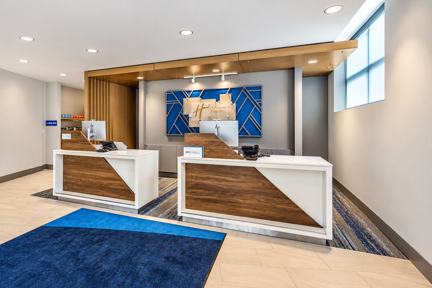 Hotel lobby front desk with custom wood-and-quartz reception counters